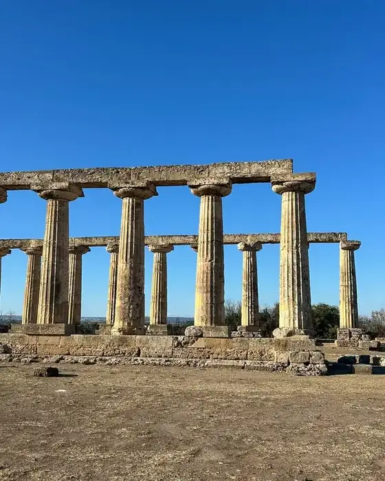 The Tavole Palatine, the Doric columns of the temple of Hera at Metaponto, under a deep blue sky